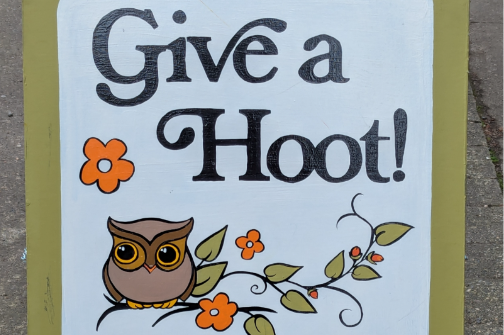 A folding sign that has an owl on it and it says give a hoot to vintage and resell.