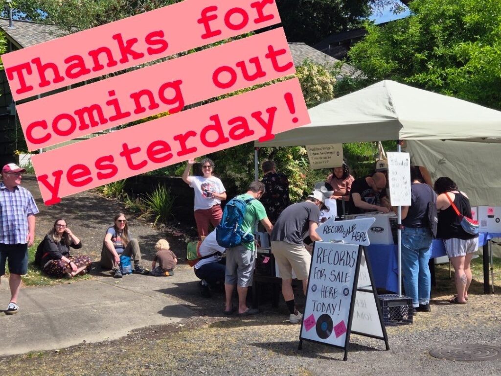 A thank-you photo from a neighborhood record sale, featuring a white tent with people flipping through records and chatting. A bold pink caption says “Thanks for coming out yesterday!” across the top of the image.